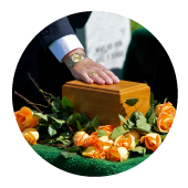 Hand on casket and flowers